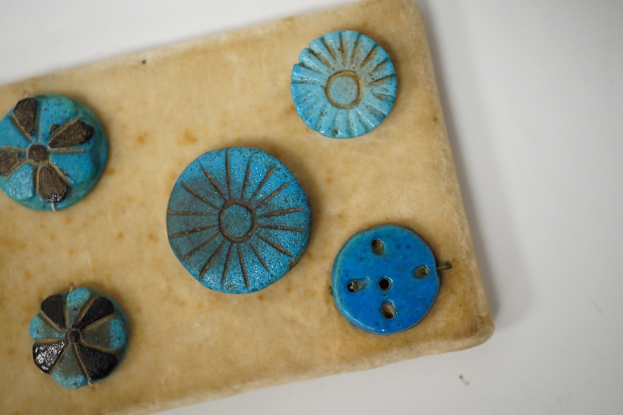 Antiquities - a group of eight blue glazed composition rosettes/buttons, used for garment decoration, 1000B.C - 600 B.C., largest 22mm. Condition - good for age and use